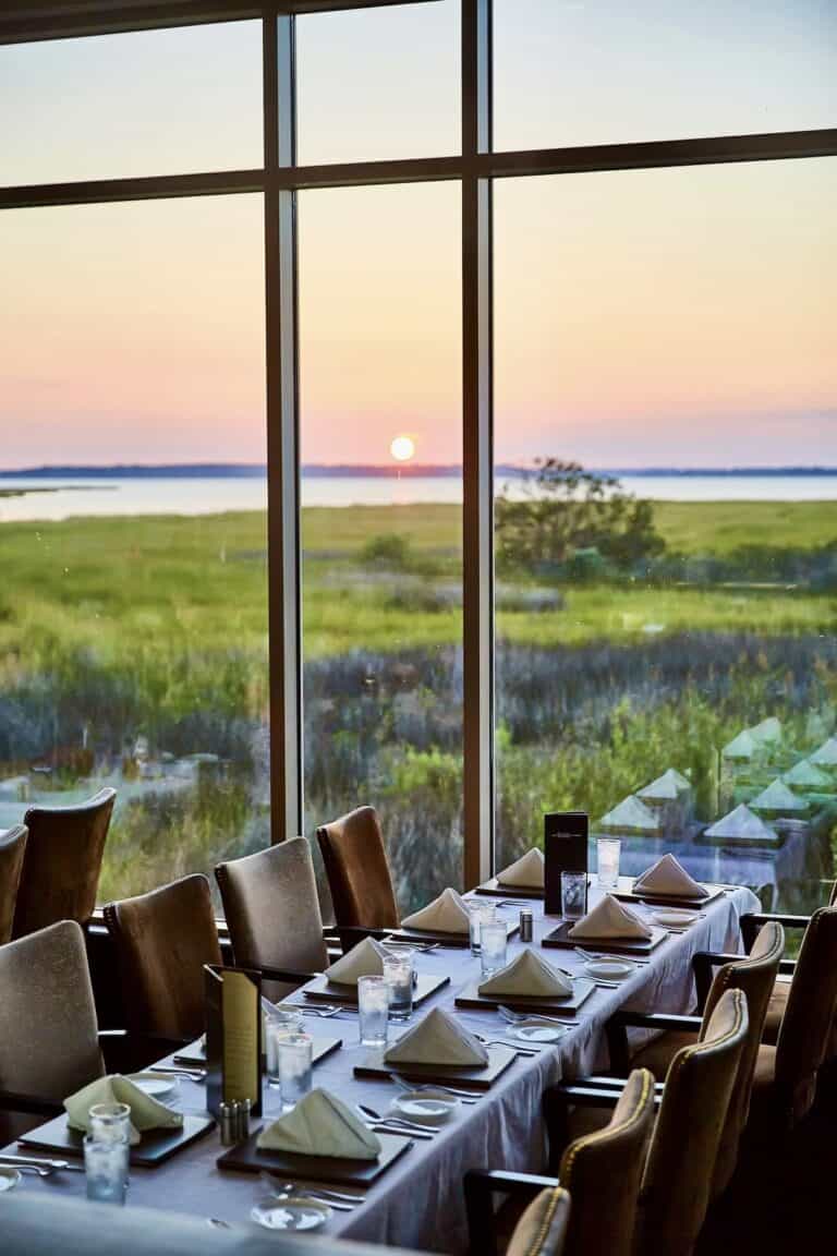 Elegant table setting overlooking the marsh and bay sunset at The Hobbit Bayside in Ocean City, Maryland