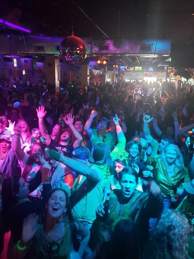 Packed crowd and disco ball inside the Purple Moose Saloon live music bar on the Ocean City Maryland boardwalk