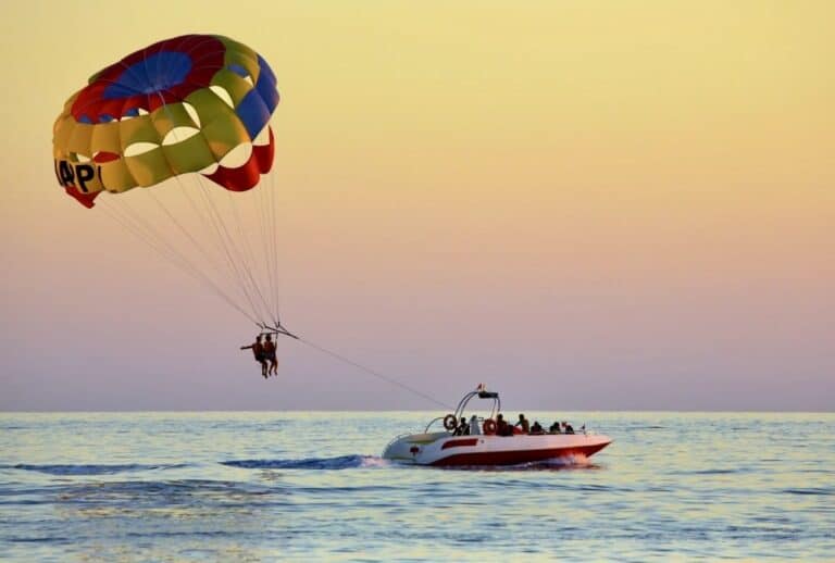 Parasailing watersport on a boat bay side in Ocean City, Maryland at sunset