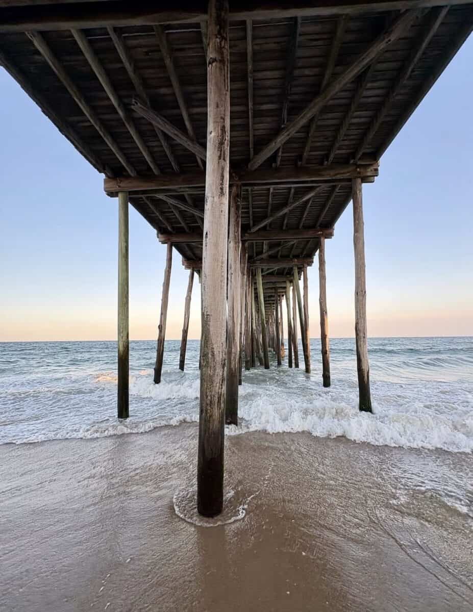 View underneath the fishing pier at sunrise in Ocean City, Maryland